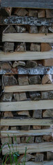 Fragment of a woodpile of birch firewood. Birch firewood is stacked. Chopped firewood is piled up.