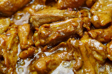 Chicken pieces in a sauce with paprika and turmeric in gravy
