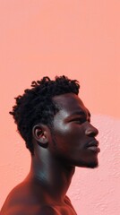 Striking Portrait of Young Man with Intense Gaze Against Coral Background