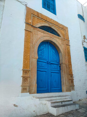 Aged and colorful Andalusian-style doors, with their classic Arabic ornaments, they decorate the entrance to the blue and white houses of the village of Sidi Bou Saïd. Tunisia