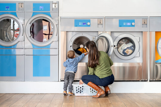 Mother and little boy doing laundry