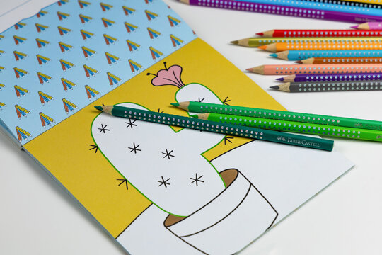 Faber-Castell colored pencils for drawing various colors and coloring book for children.