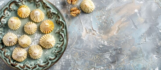 Arabic desserts. Traditional maamoul cookies for Eid made with semolina, filled with dates, walnuts, and pistachios. Image captured from above with empty space for text. - obrazy, fototapety, plakaty