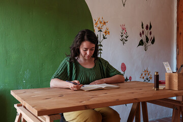 woman writing notes in a desk