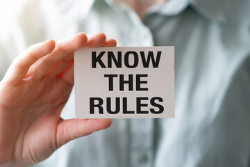 Know the rules text on an sticker in hand on a white background