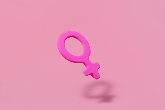 Female gender icon on isolated pink background.