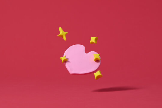 Pinklay heart on a red background, minimal valentine theme