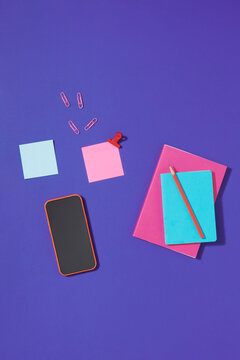 Notepad with blank pages, pen, mobile phone and sticky note blocks
