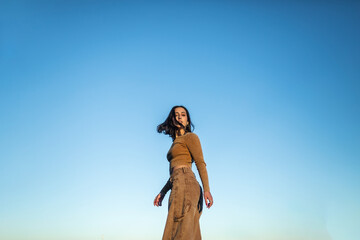 woman dancing with blue sky as background