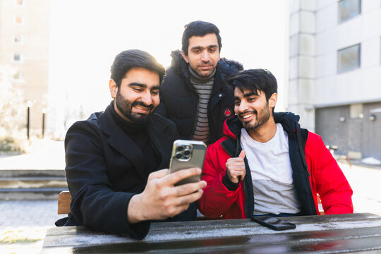 Happy student colleges having a video call