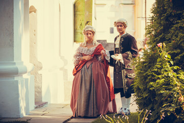 Portrait of blonde woman and man dressed in historical Baroque clothes