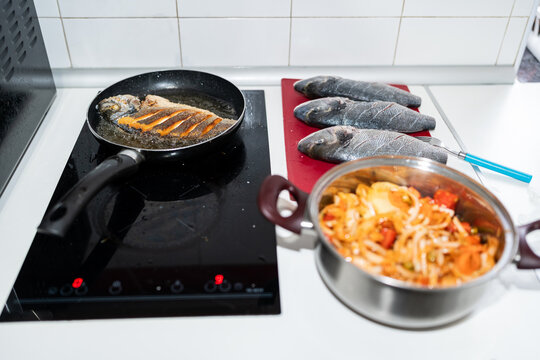 Cooking fish in a pan.