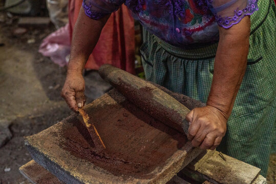 Hands making chocolate from beans