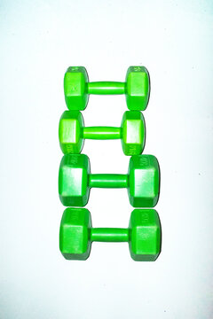 Neon green sport equipments dumbbells with hard direct flashlight