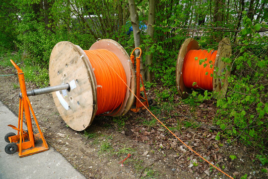 Laying an orange fiber optic cable in the ground, underground cable for faster internet in rural areas, near the city Alfeld, Lower Saxony, Germany, Europe