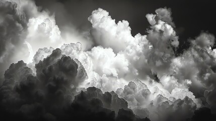 A grayscale image of storm clouds. The clouds are dense and appear to be building.