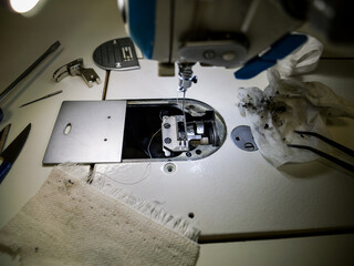Cleaning and changing the foot of a straight professional sewing machine. Maintenance