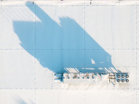 Rooftop air conditioner / HVAC units covered with snow.