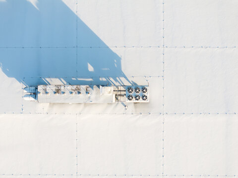Rooftop air conditioner / HVAC units covered with snow.