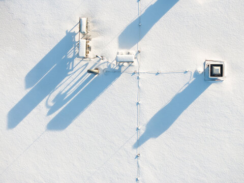 Rooftop air conditioner / HVAC units covered with snow.