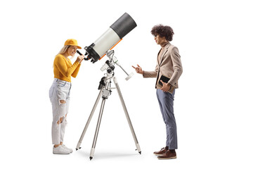 Man talking to a young female observing the planets and stars with a telescope