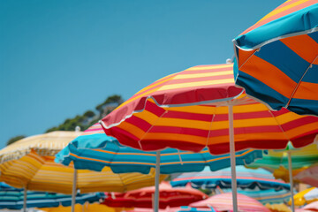 Colorful umbrellas on sandy beach. Travel and vacation background. Generative AI