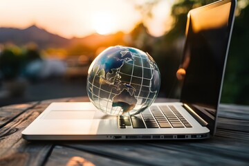 Glass globe on laptop symbolizes global business perspective - obrazy, fototapety, plakaty