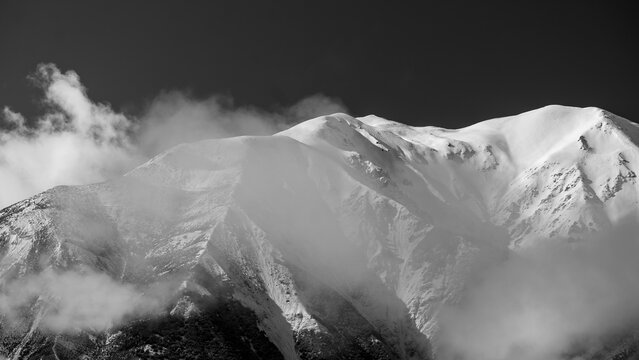Light hitting mountain peaks with cloud