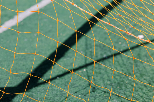 Orange net on the grass background 