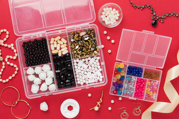 Tools and beads for making handmade jewelry on color background, top view