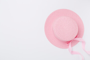 Pink hat on color background, top view. Summer concept