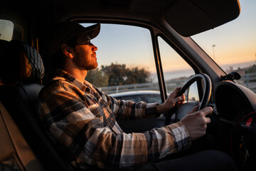 Man driving at sunset