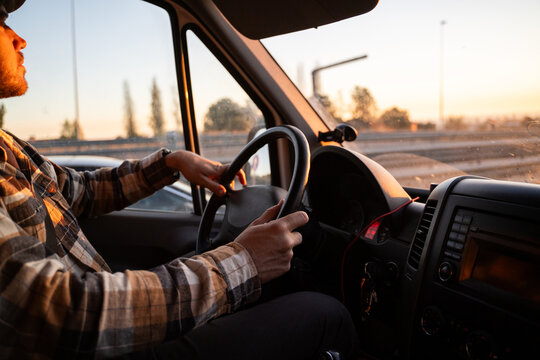 Man driving at sunset