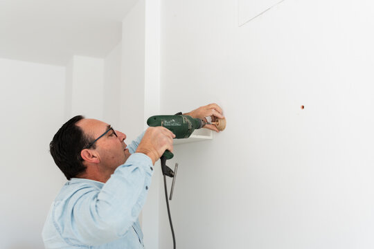 man using a drill.