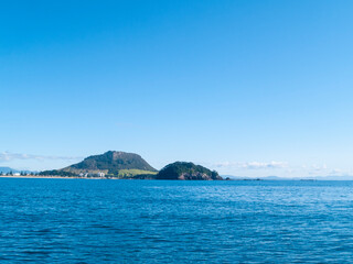 Mount Maunganui landmark beyond blue sea