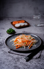 Daikon radish carrot noodles salad in a plate