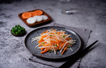 Daikon radish carrot noodles salad in a plate