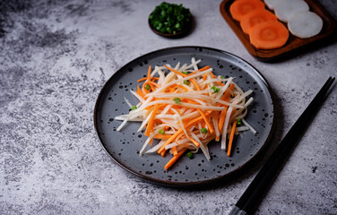 Daikon radish carrot noodles salad in a plate