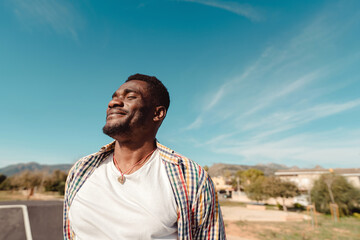 Satisfied and hopeful young black man portrait