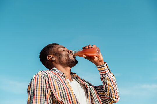 Black man drinking juice