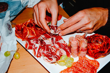 man preparing a charcuterie board