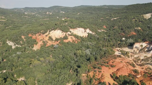 Aerial footage of Red sands and abstract Rustrel canyon moher cliffs landscape. Provencal Colorado near Roussillon,in the Vaucluse department - Southern France.