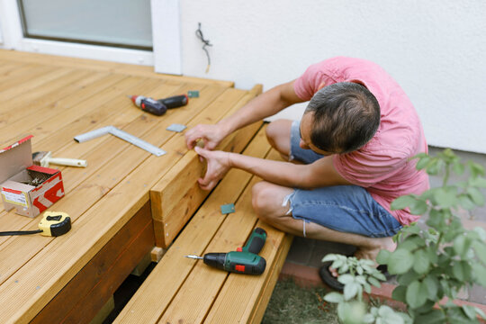 a man makes a terrace in the yard