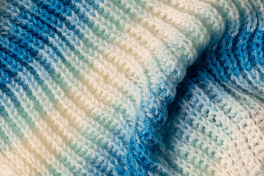 White and blue knitted wool pattern macro