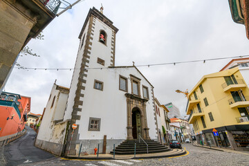 The whitewashed facade and bell tower of the 18th century St. Peter's Catholic Church, or Igreja de...