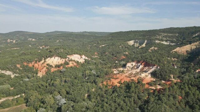 Aerial footage of Red sands and abstract Rustrel canyon moher cliffs landscape. Provencal Colorado near Roussillon,in the Vaucluse department - Southern France.