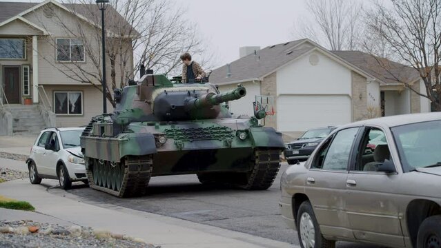 Teen backing tank up into a car - slow motion