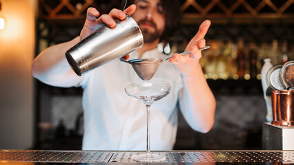 Expert Bartender Skillfully Crafting a Stylish Cocktail