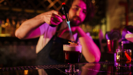 Bartender Skillfully Prepares Cocktail at Vibrant Nightclub