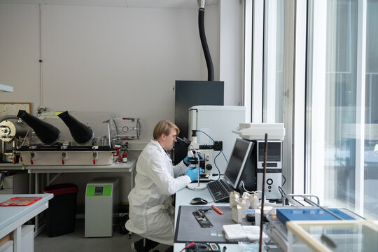 Male Researcher Using The Microscope